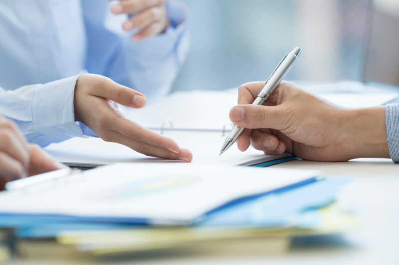 A man is signing a contract